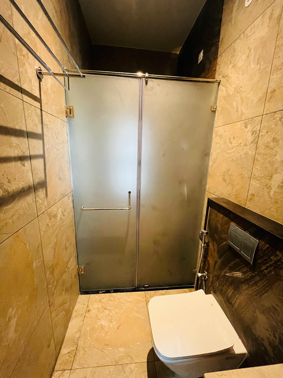 Sliding door shower enclosure in compact Mumbai bathroom