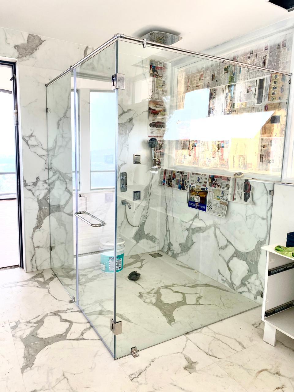 Corner shower enclosure with brushed gold fittings